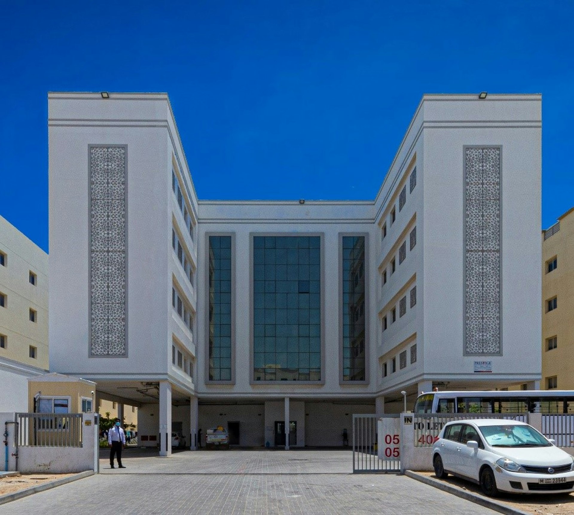 a white car parked in front of a building